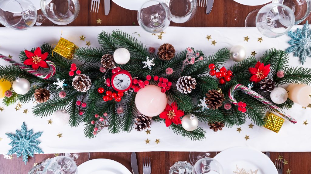 Tavola di Natale con decorazioni natalizie su tavolo di legno scuro, piano di posa